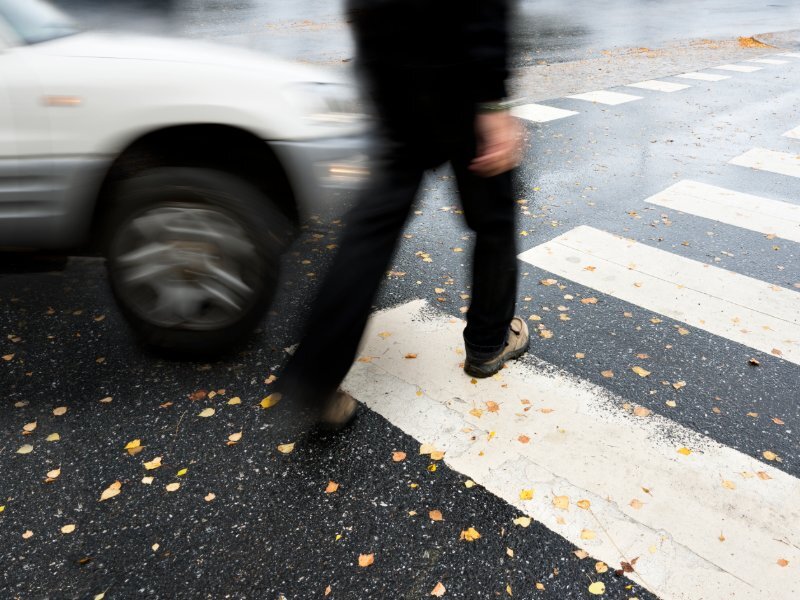 Man using crosswalk and car is approaching