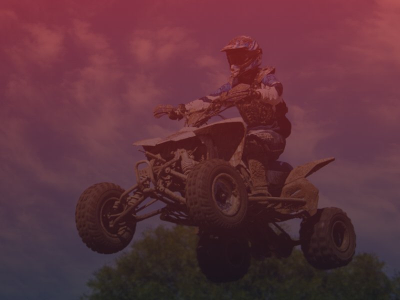 Man riding ATV on jump